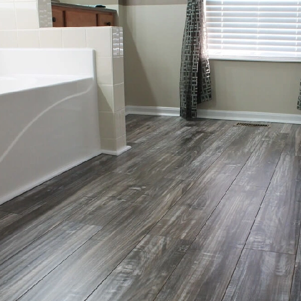 Distressed gray laminate flooring in bathroom