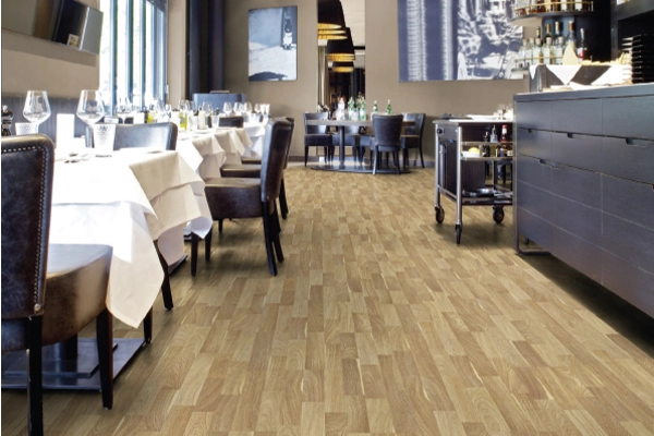 Modern bedroom with dark gray wood-look flooring.