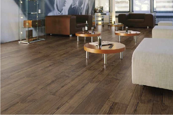 Modern lounge with dark wood laminate flooring.